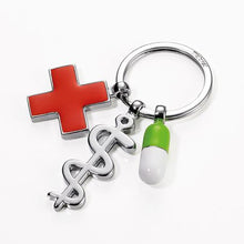 Load image into Gallery viewer, TROIKA Keyring - Keep Well with 3 Charms: Rod of Asclepius, Red Cross, Pill
